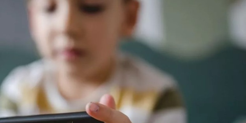 kid on phone, a young boy on phone, online safety for kids